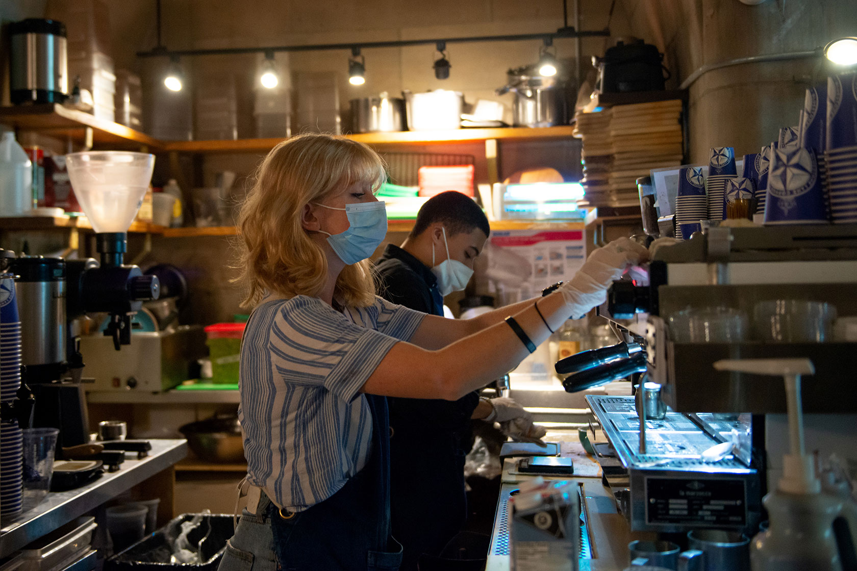 A barista wearing a mask