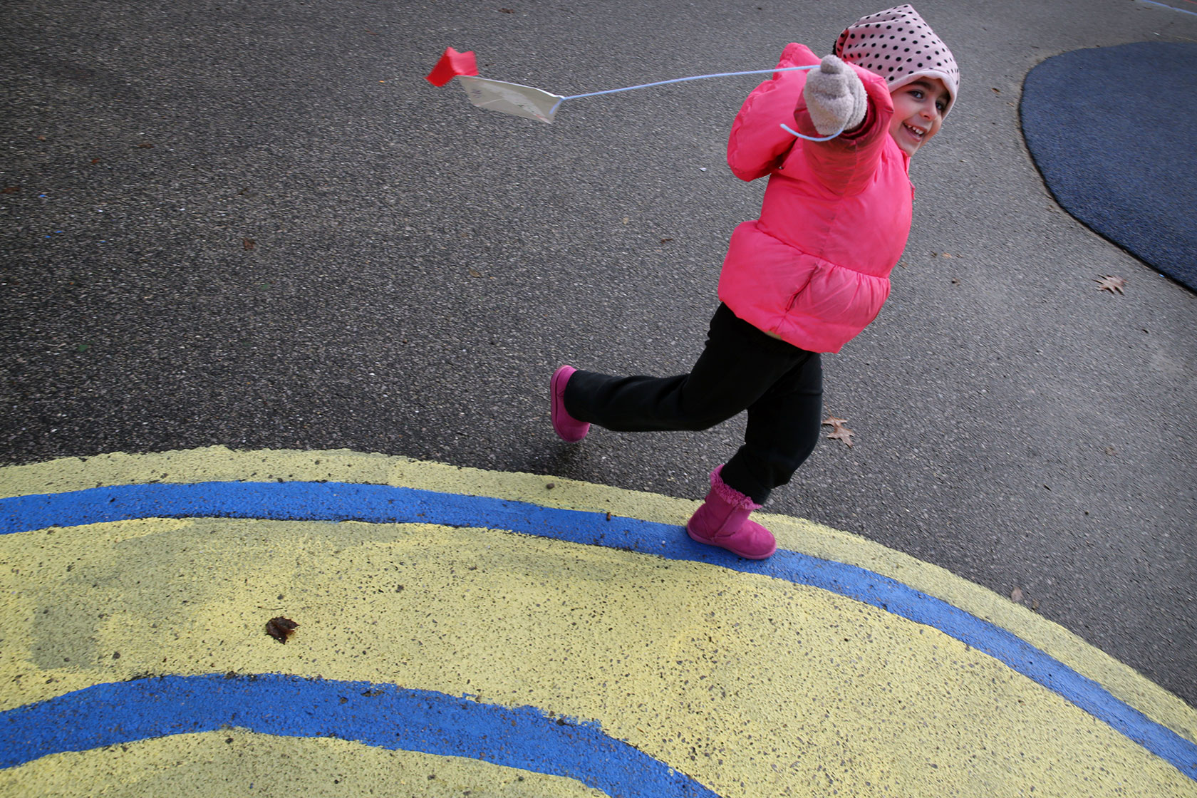 A child attempts to fly kite