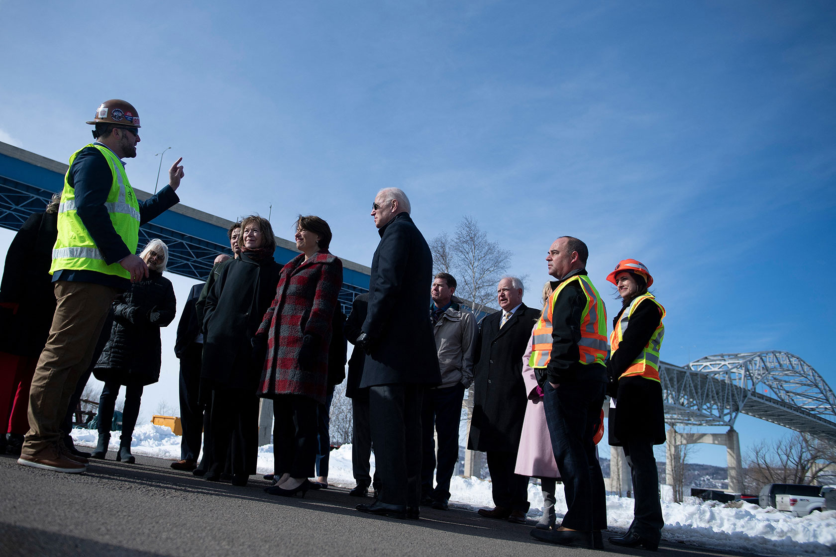 President Joe Biden in group in front of bridge