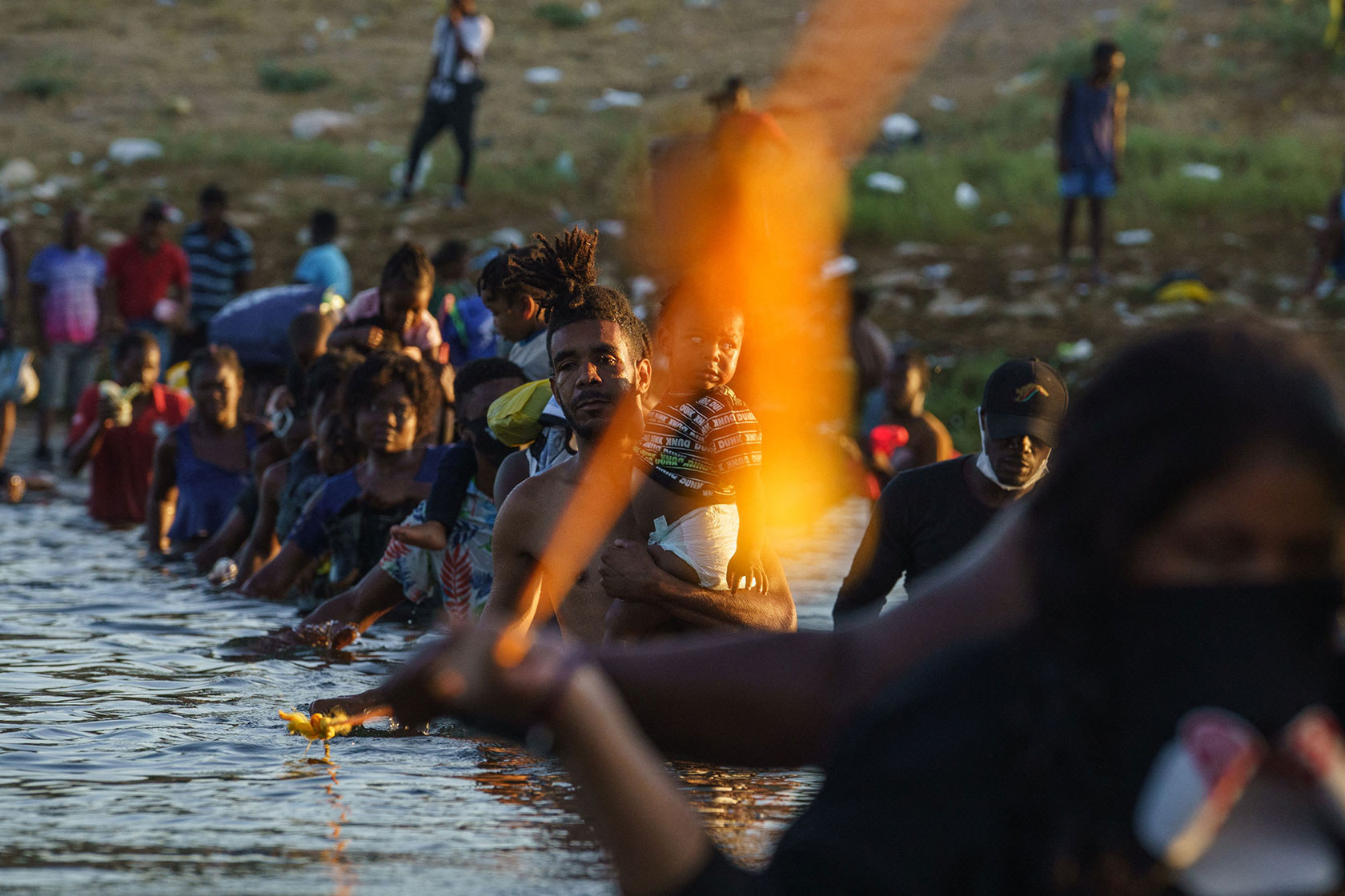 Haitian migrants crossing river