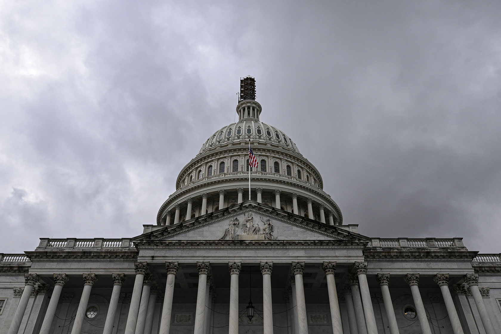 Photo shows the U.S. Capitol building dome against cloudy sky