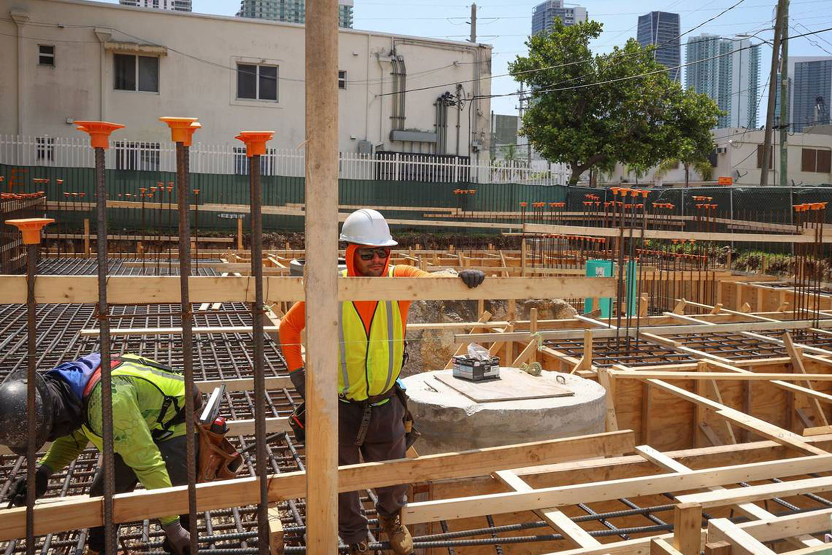 Construction workers work on the foundation of a mixed-use affordable housing project in Overtown, Miami.