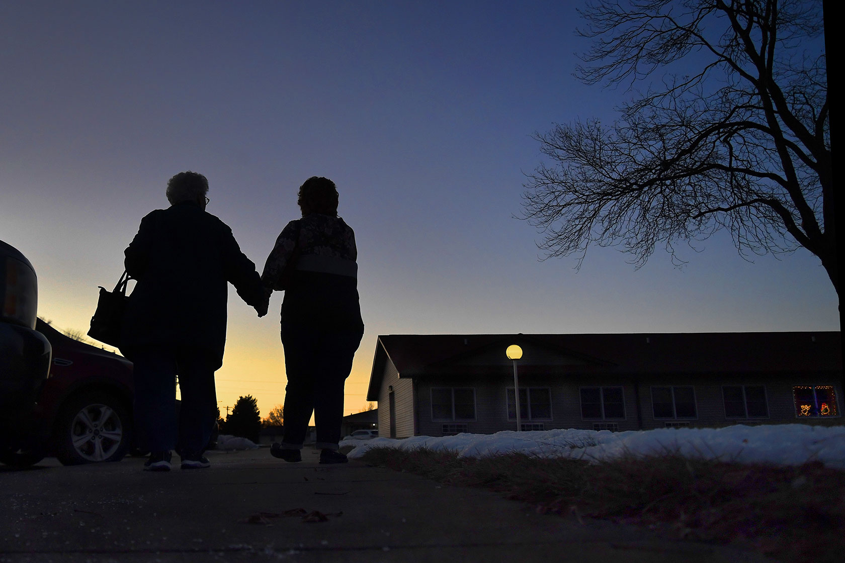 A mother and daughter hold hands in Cozad, Nebraska.