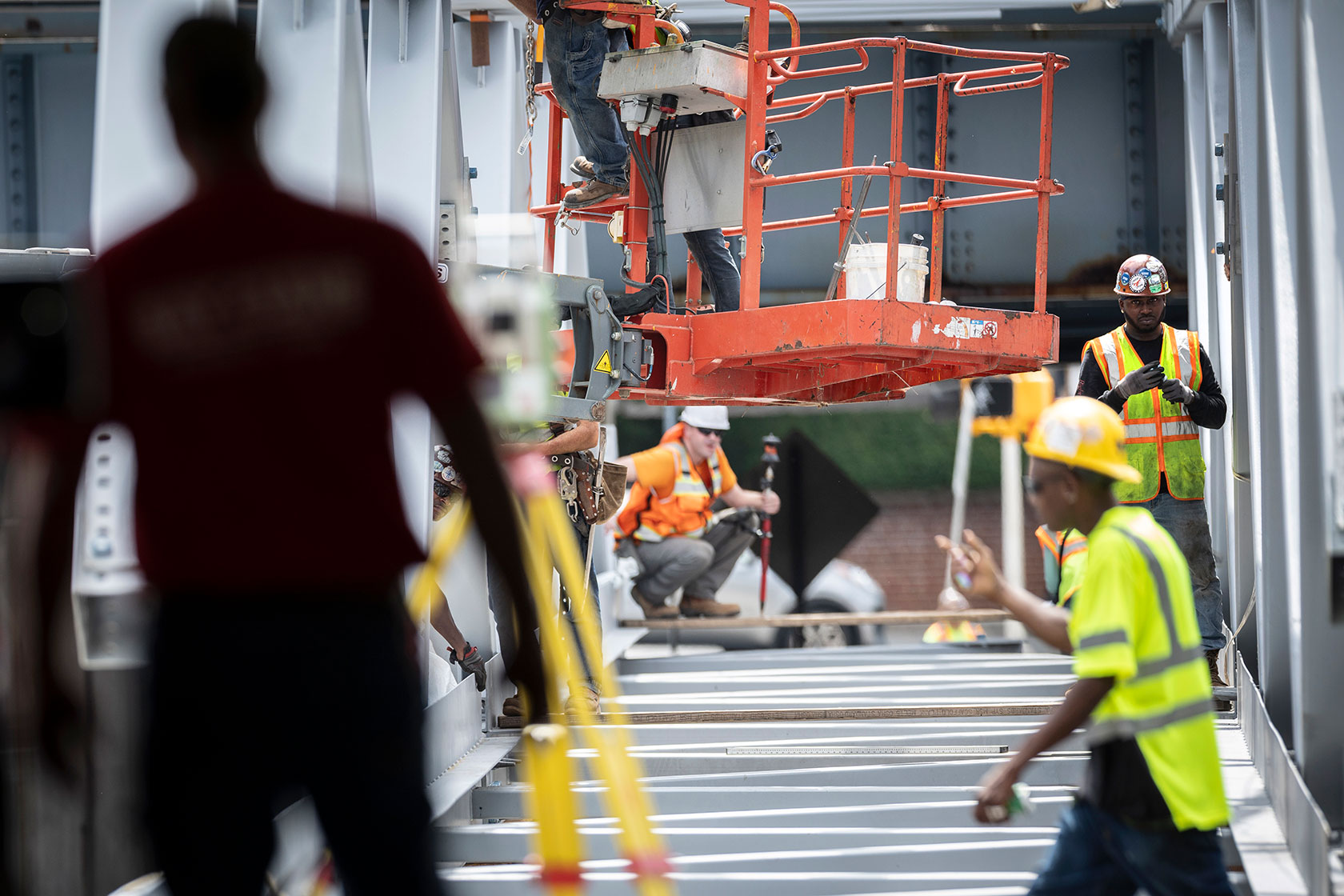 Workers prepare to lift a new pedestrian bridge into place at the Stamford Transportation Center.