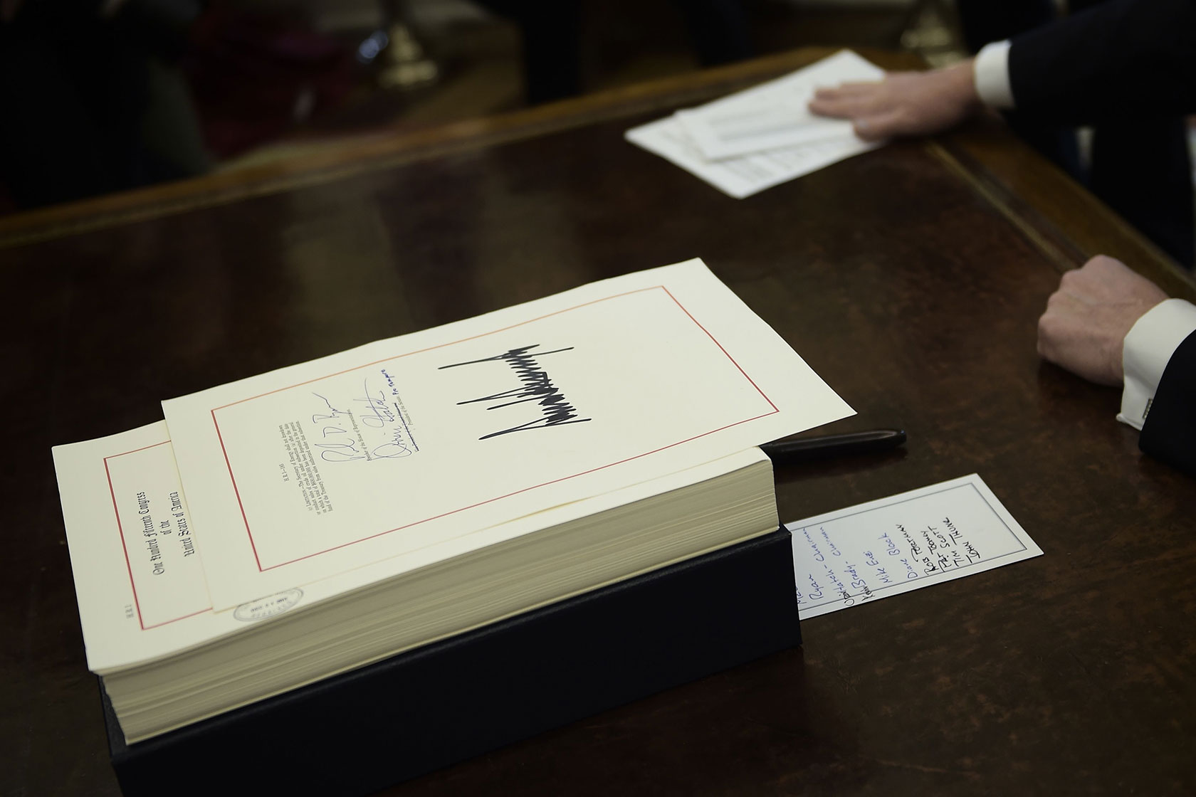 Notes are seen on the desk of then-President Donald J. Trump after signing into law the Tax Cuts and Jobs Act.