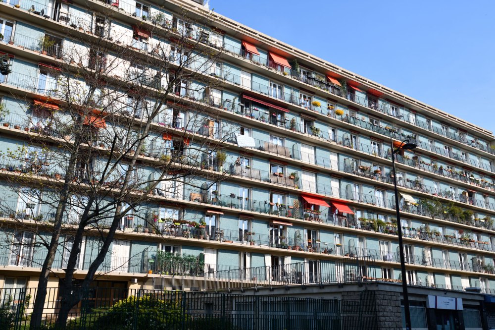 A building featuring housing for the working class is seen in the neighborhood of 