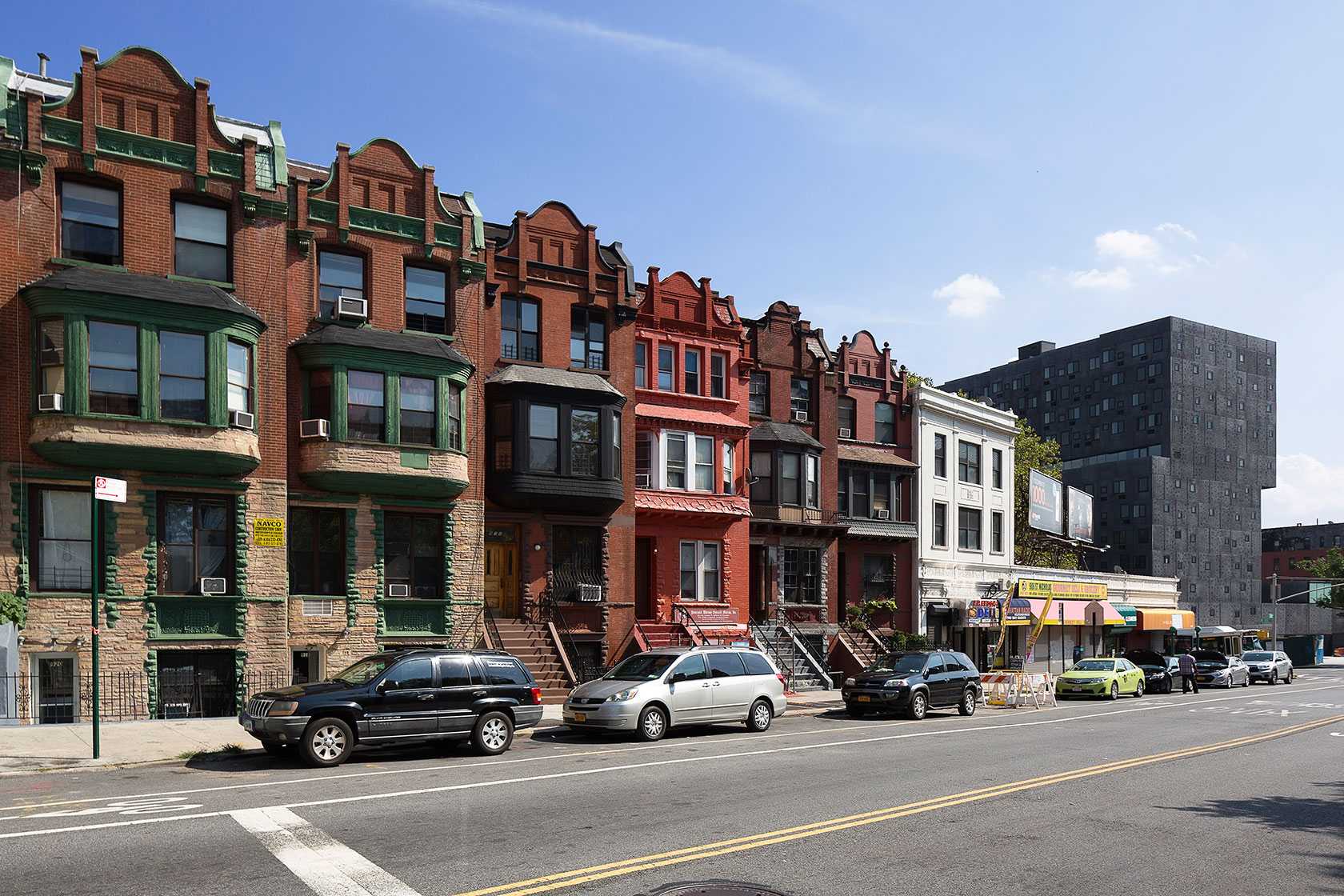 Row homes stand in front of an affordable housing development in New York.
