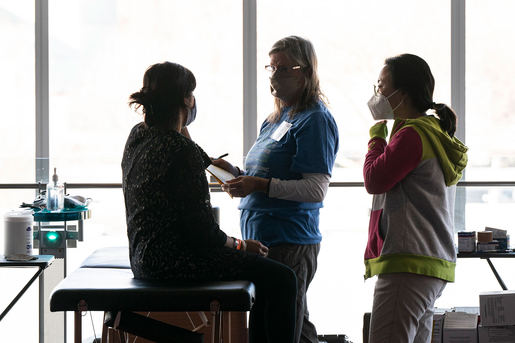 Volunteers provide medical care to a patient at a clinic in Seattle.