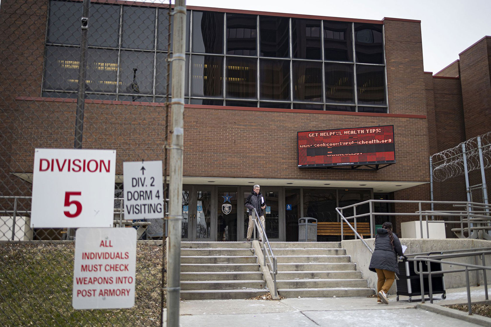 People walk outside of Division 5 of Cook County Jail.