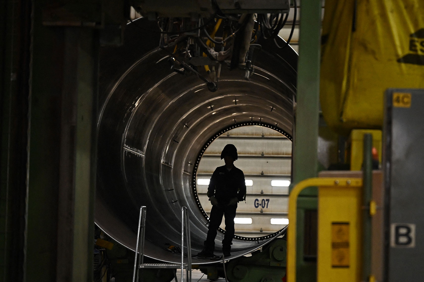 Wind turbine factory worker in shadow