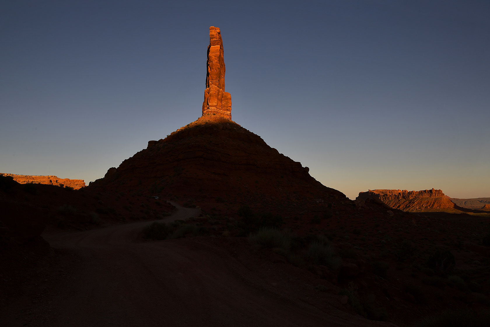 One of the towering pinnacles in Valley of the Gods within the Bears Ears National Monument is illuminated as the sun sets.