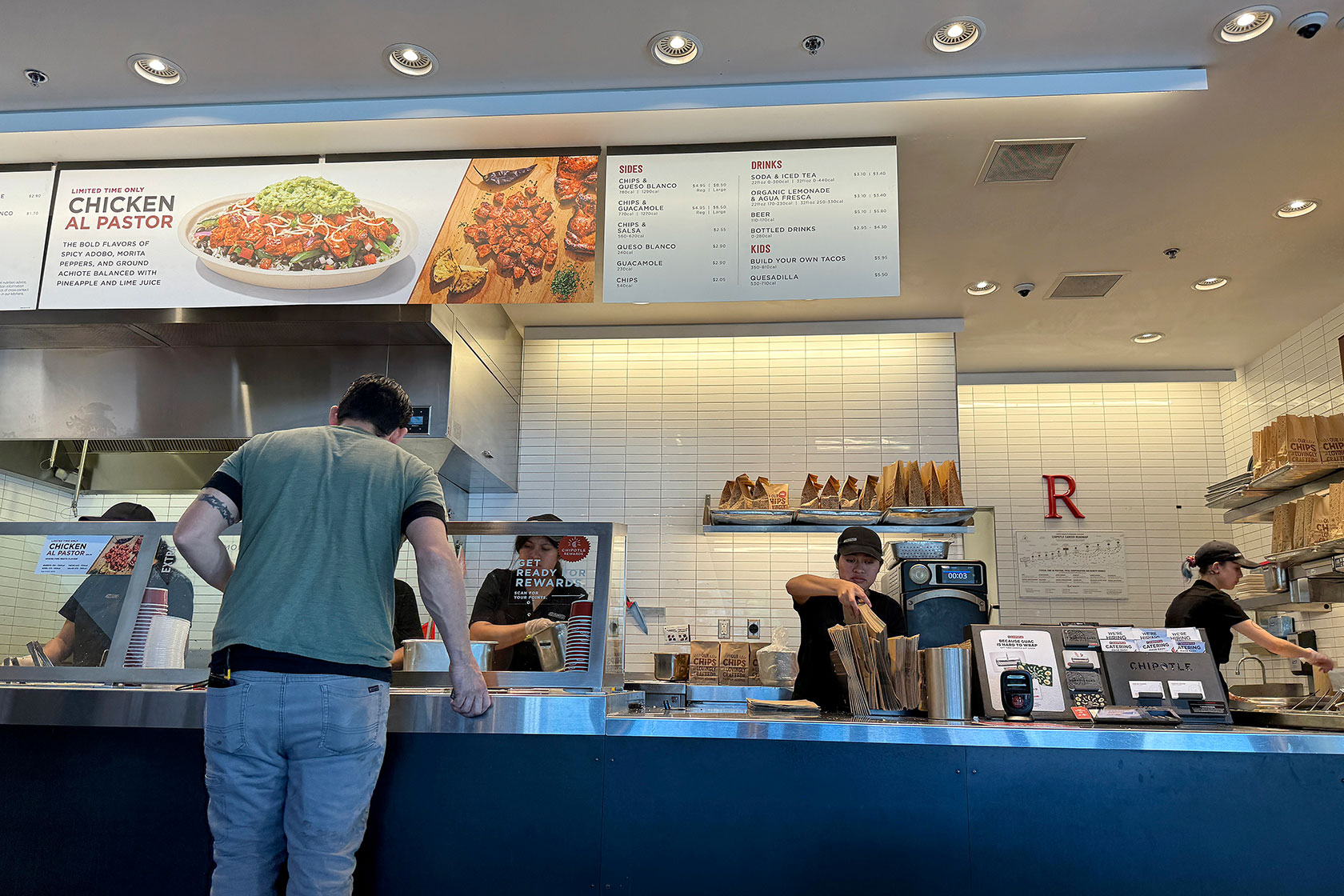 Customer at counter ordering food