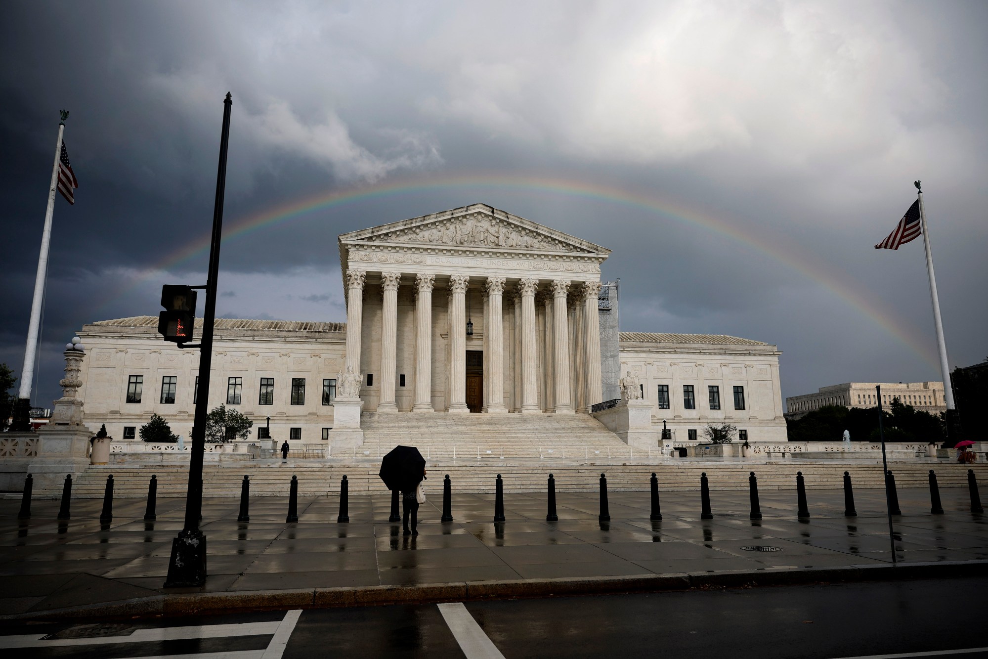 A rainbow and clouds are seen above the U.S. Supreme Court building.