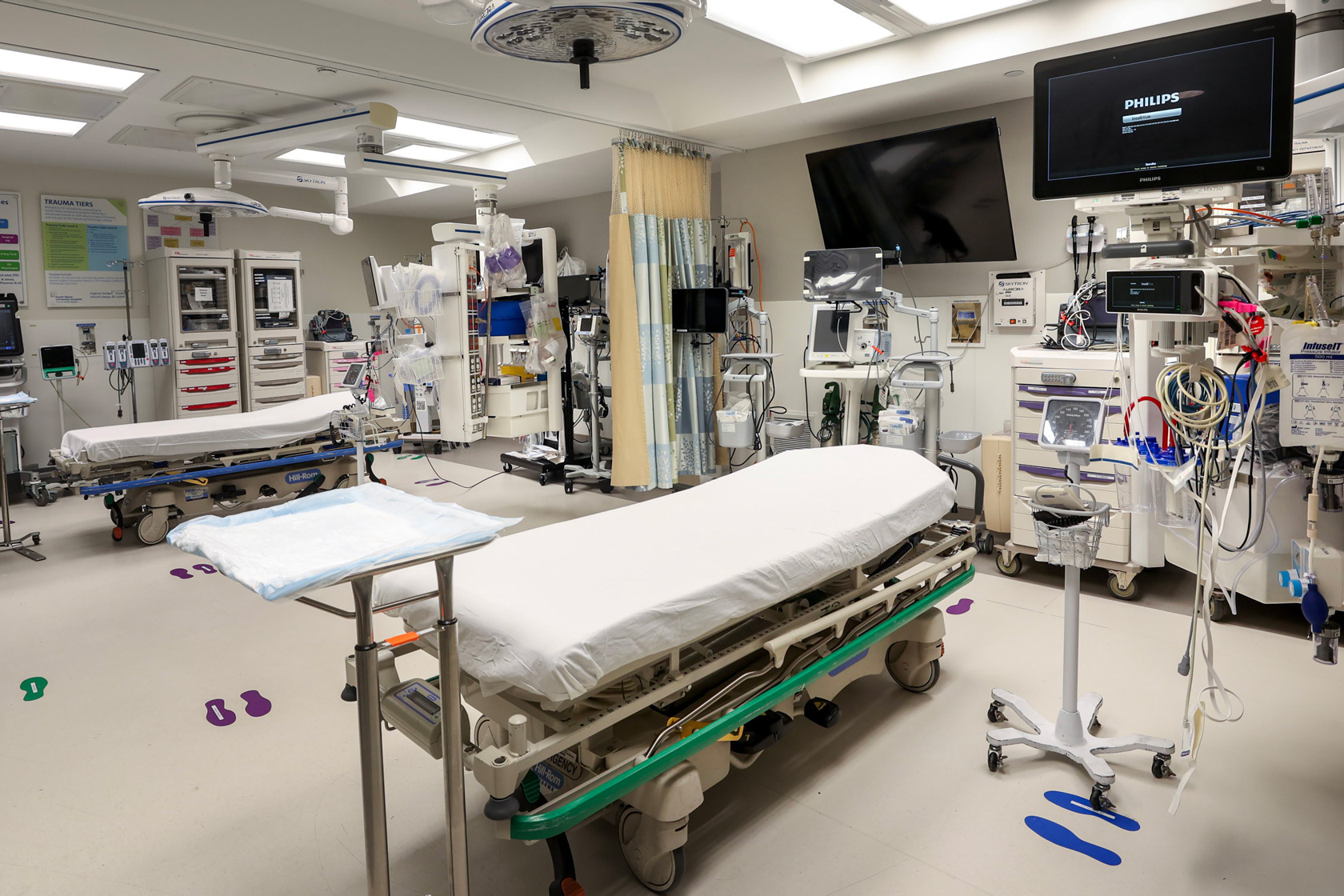 An empty hospital bed stands in a trauma bay at South Shore University Hospital in Bay Shore, New York.