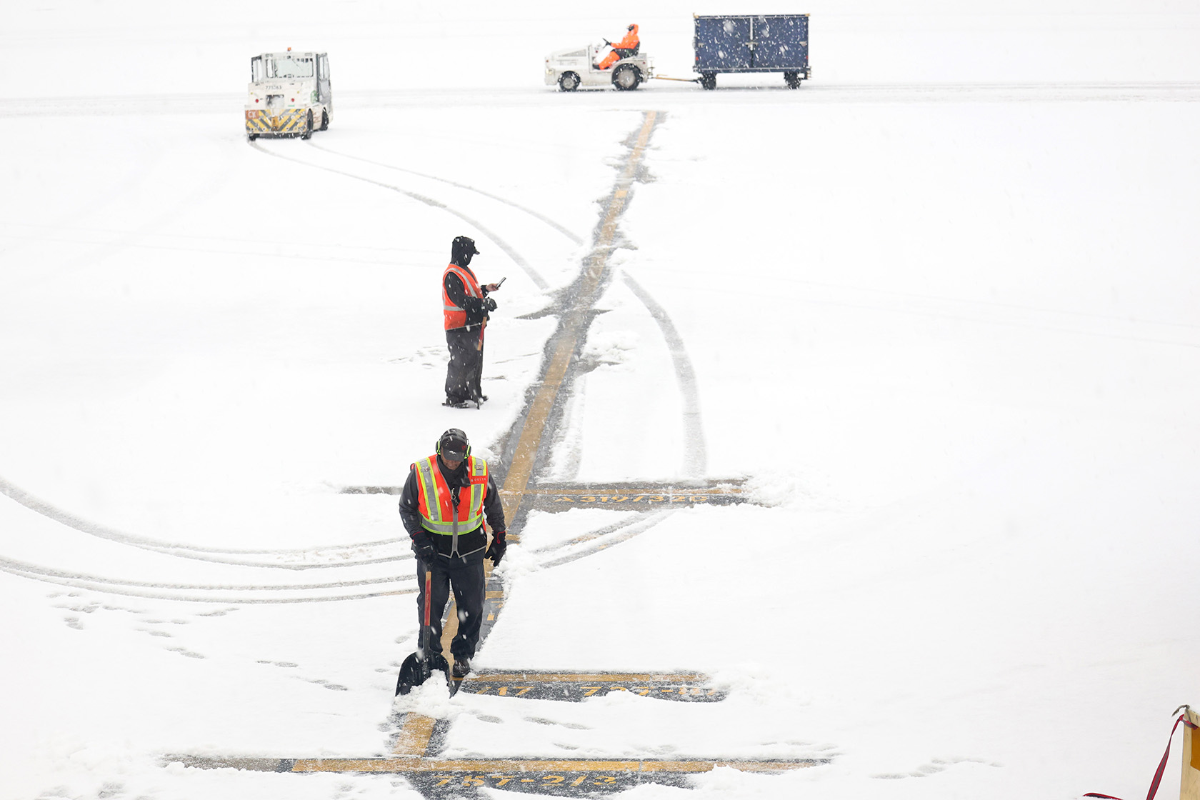 Workers shovel snow as it blankets the Hartsfield-Jackson Atlanta International Airport.