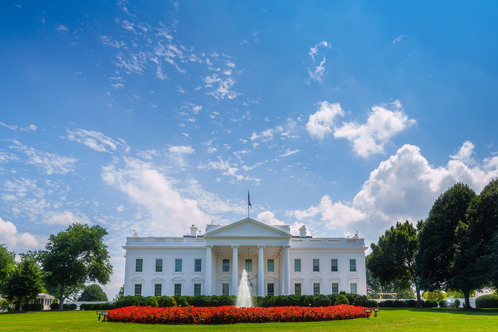 Exterior of The White House under a blue sky