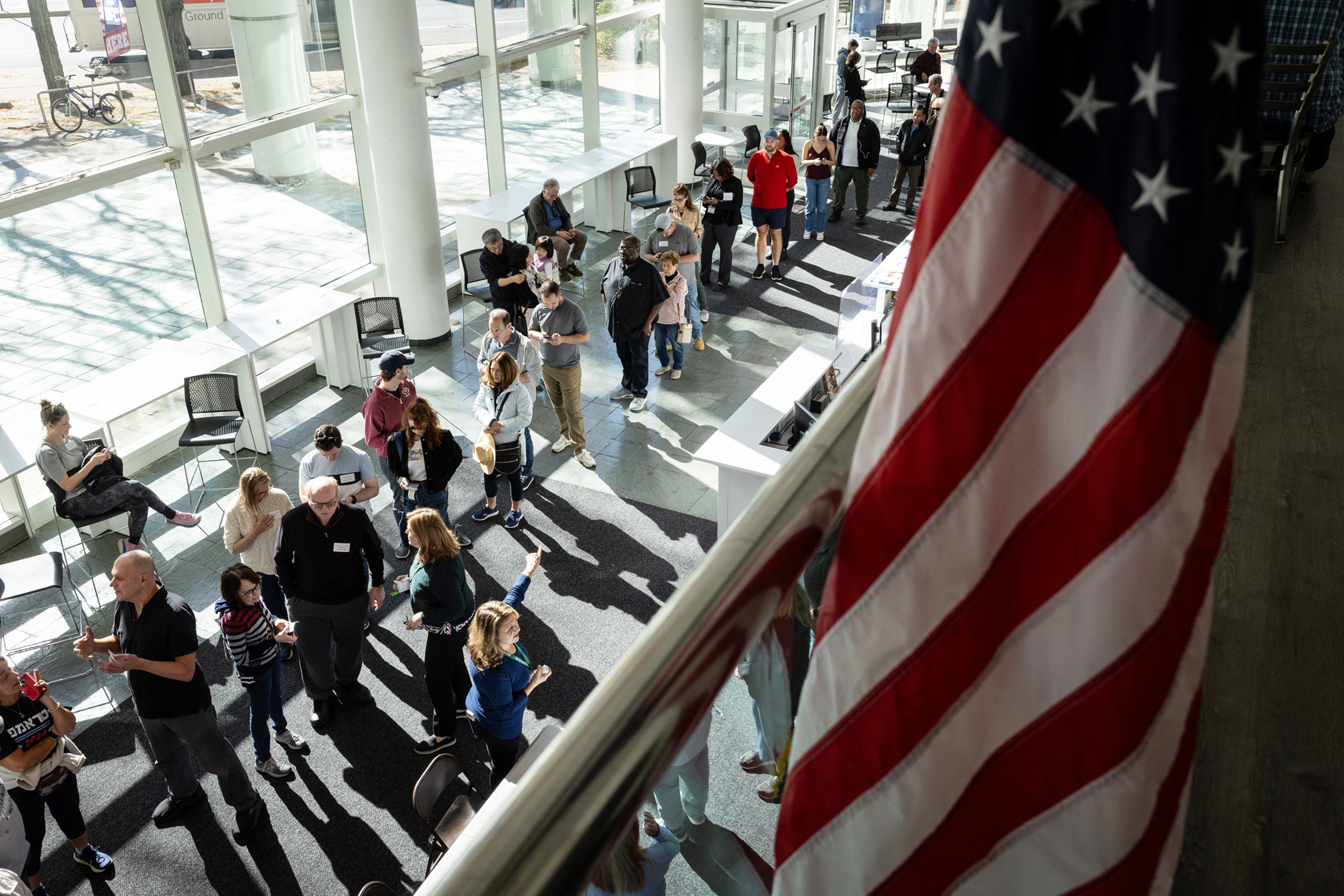 A group of voters stands in line to cast early ballots at the Stamford Government Center in Stamford, Connecticut, October 21, 2024.