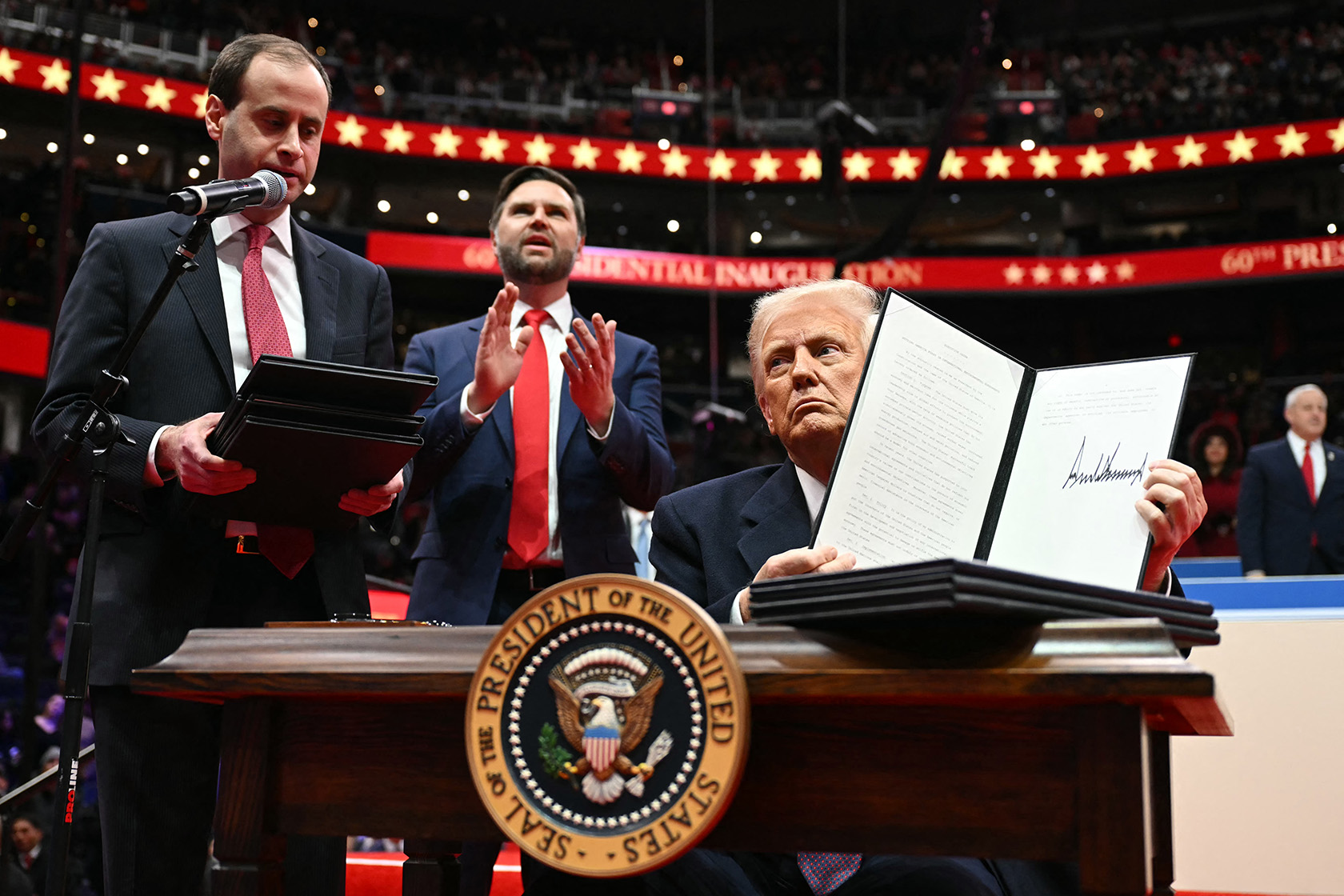 U.S. President Donald Trump holds an executive order announcing the United States’ withdrawal from the Paris Agreement .