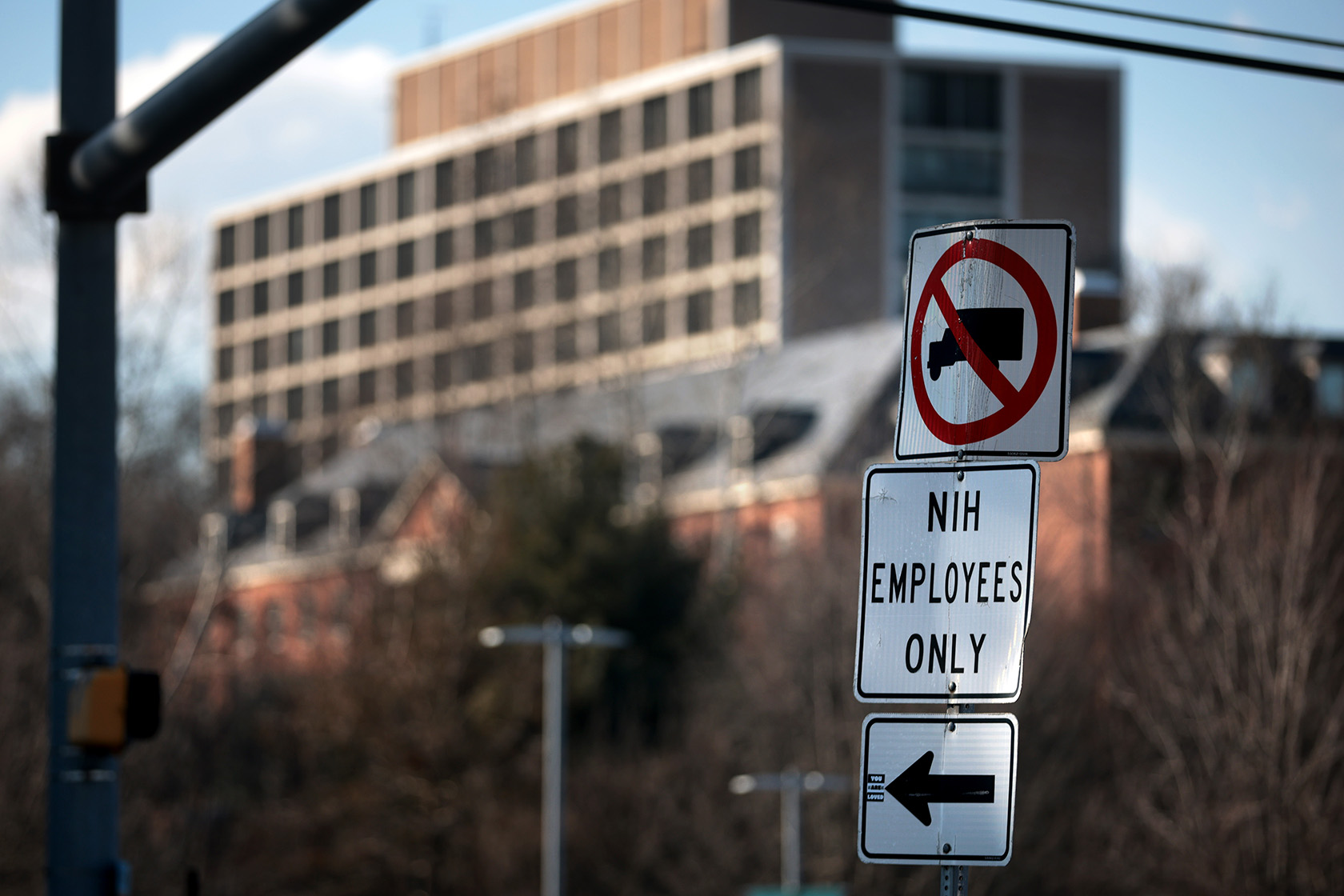 A sign stands near an entrance to the National Institutes of Health.