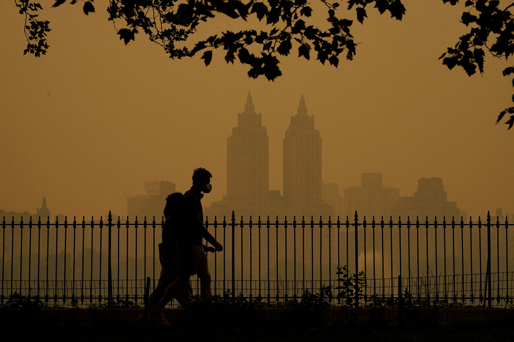 People walk in Central Park amid hazy conditions in New York City.