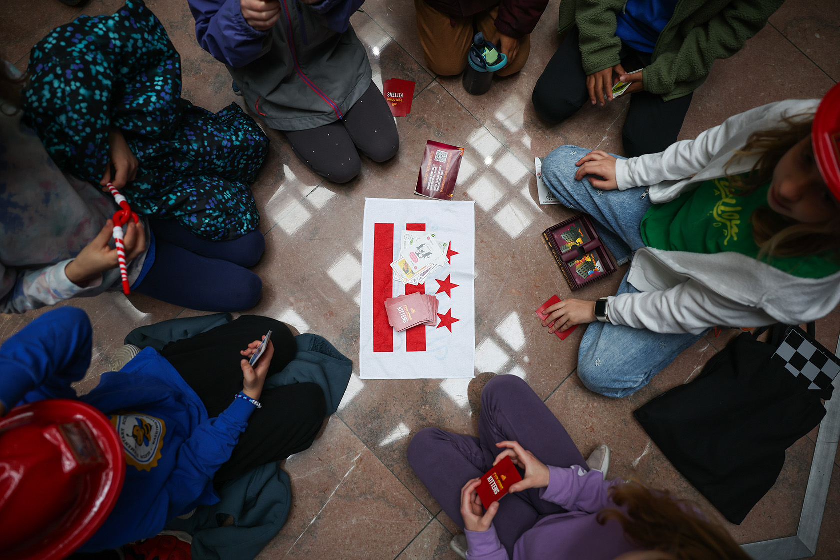 Children play games on the floor of the U.S. Capitol during a rally in support of the U.S. Department of Education.