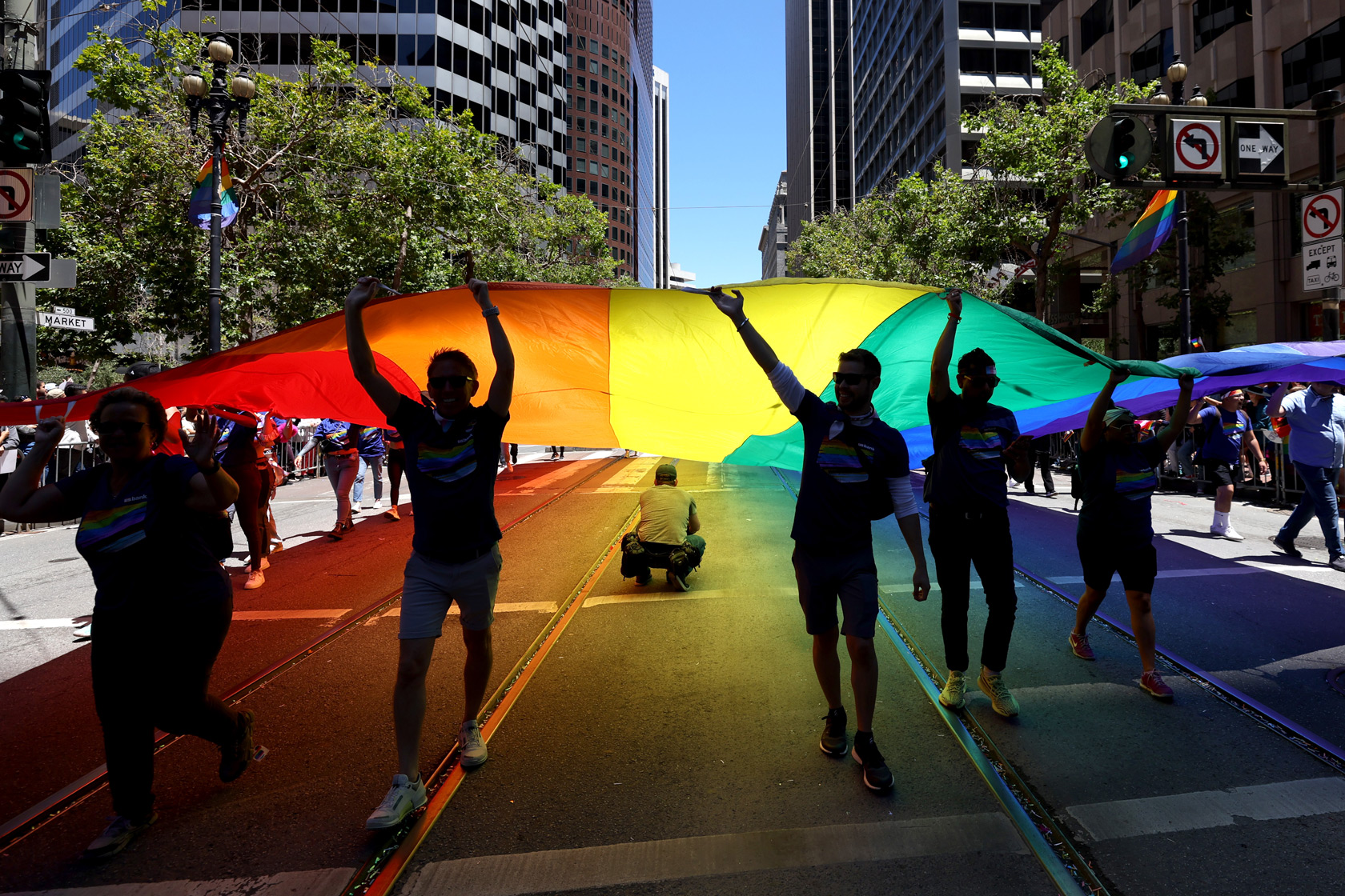 People carry a Pride flag through the streets of San Francisco.