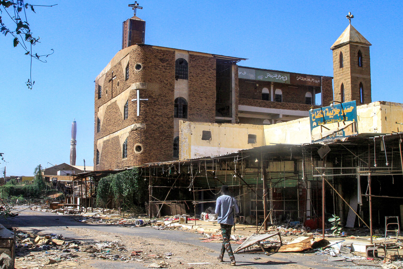 A man walks past a damaged building in Khartoum North, Sudan.
