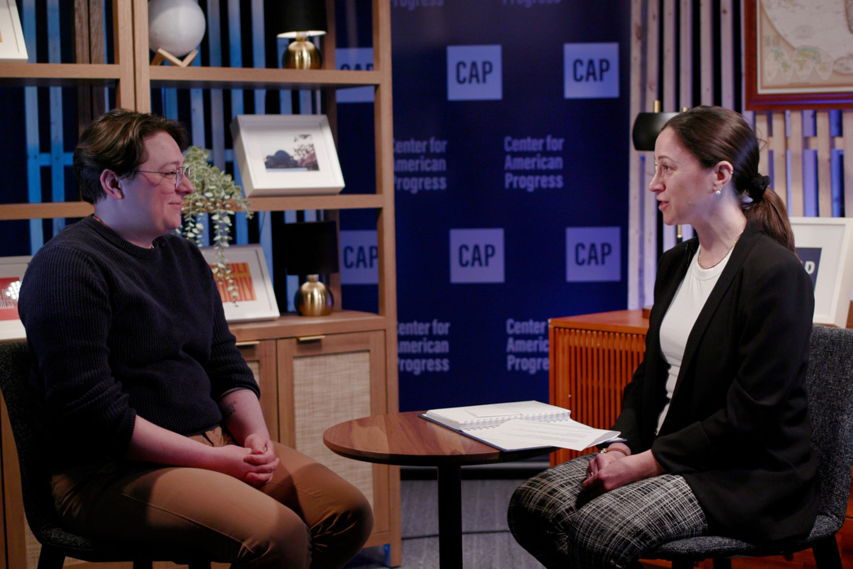 Caleb Smith, left, and Allison McManus, right, discuss USAID cuts.