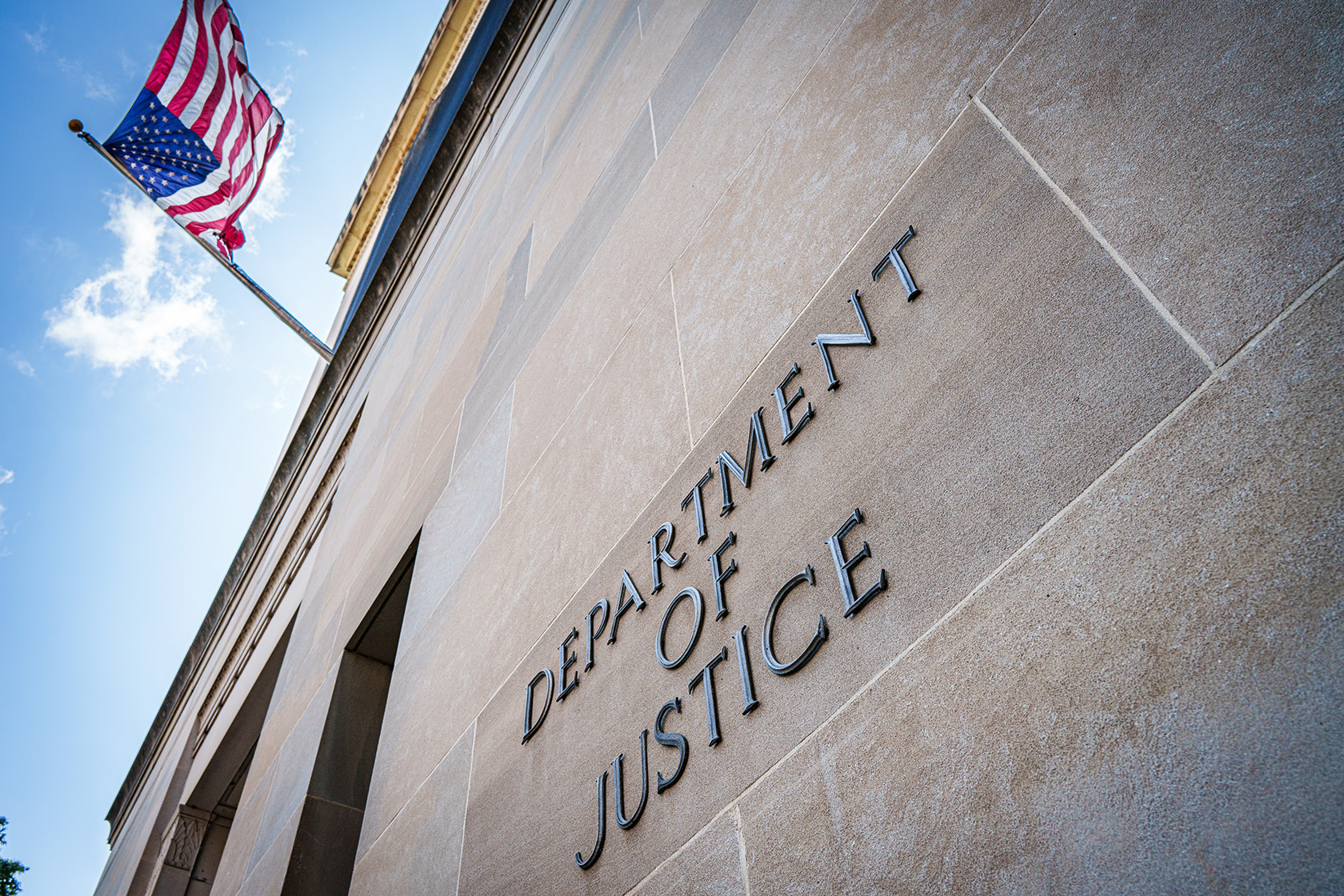 A U.S. flag flies on the side of the U.S. Department of Justice headquarters building.