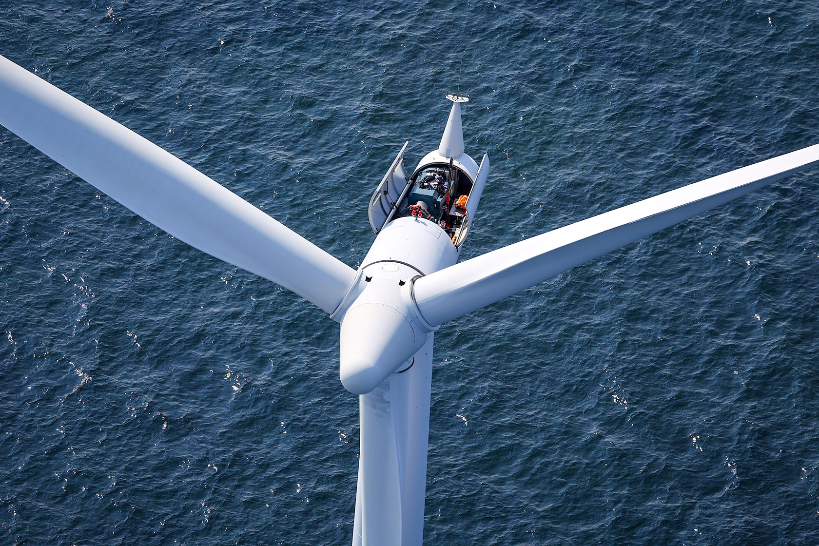 A worker stands on a wind turbine at the Middelgrunden Offshore Wind Farm in Copenhagen, Denmark, on August 18, 2022.