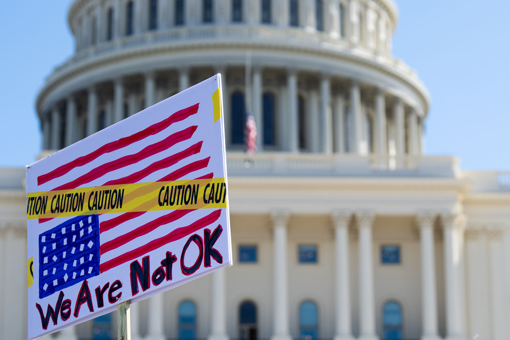 A sign is seen in front of the U.S. Capitol building.