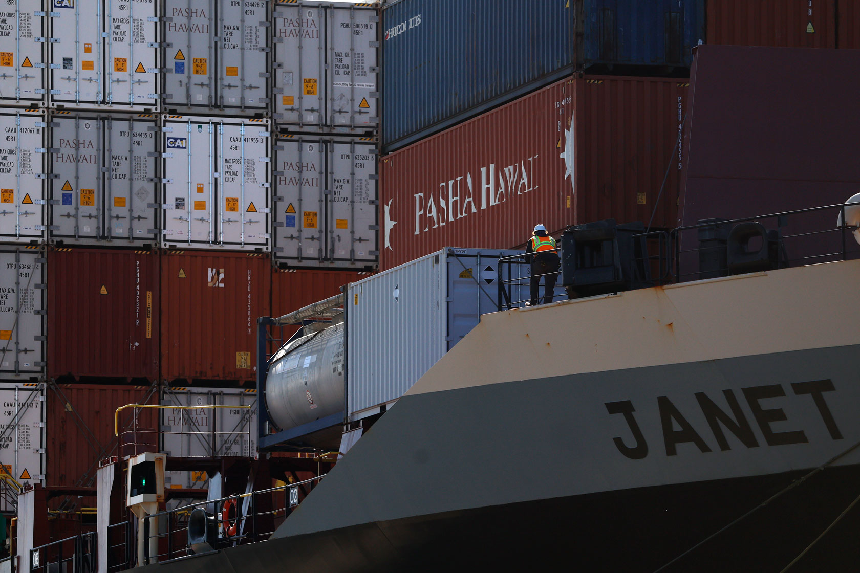 A worker is seen in front of shipping containers at the Port of Oakland in Oakland, California, April 2, 2025.