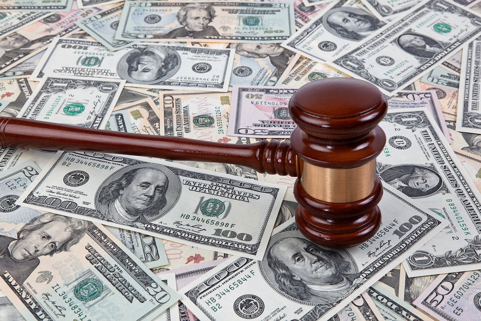 Gavel on top of U.S. banknotes