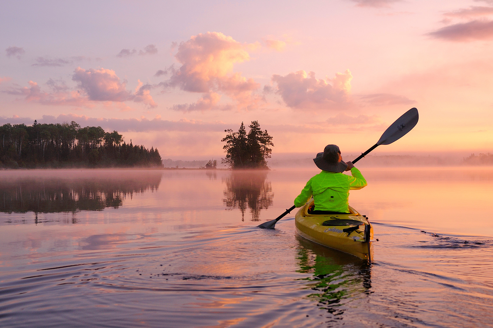 A kayaker paddles across Birch Lake.