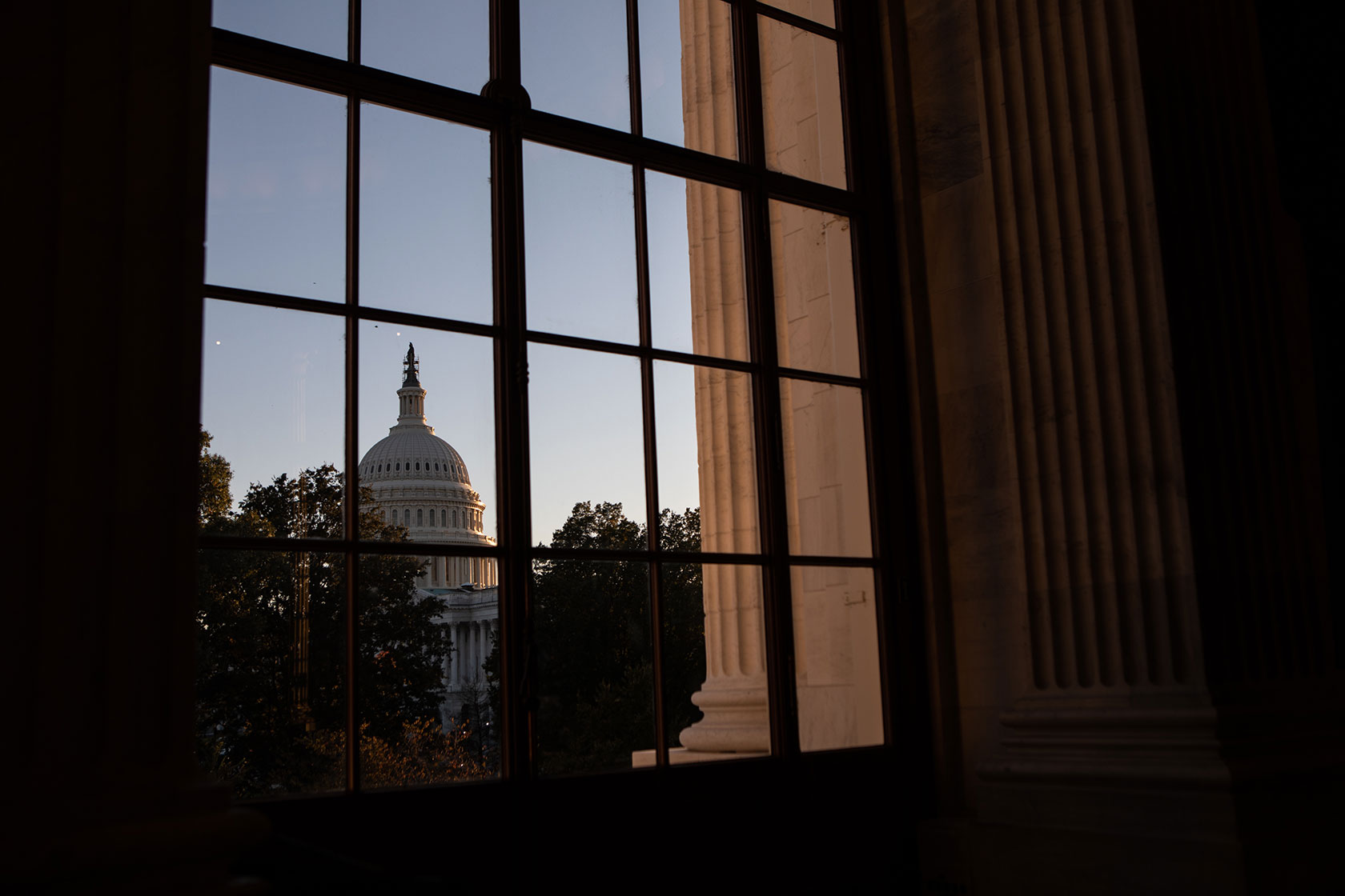 The U.S. Capitol Building is seen through a window