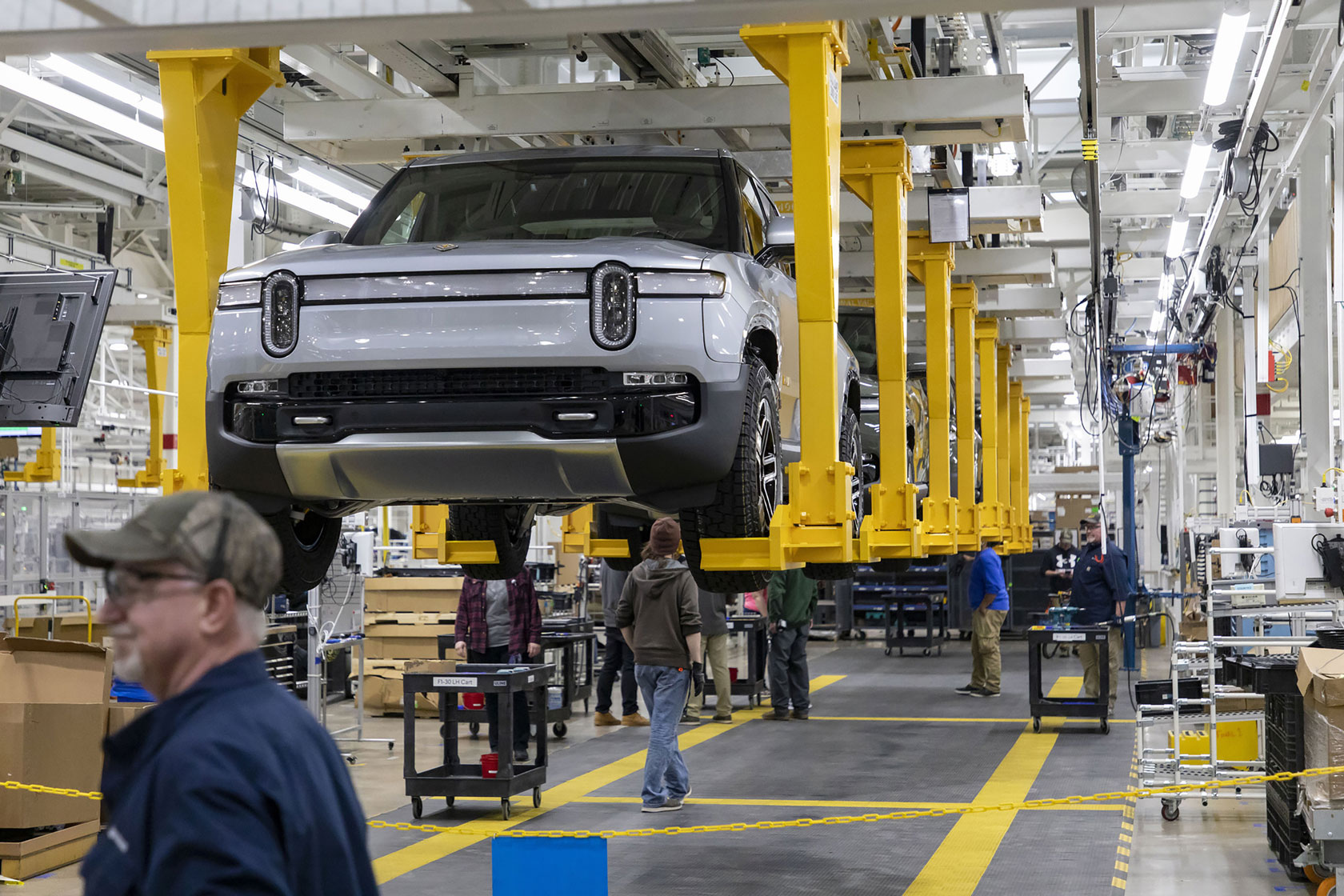 Electric vehicles are seen on the assembly line.