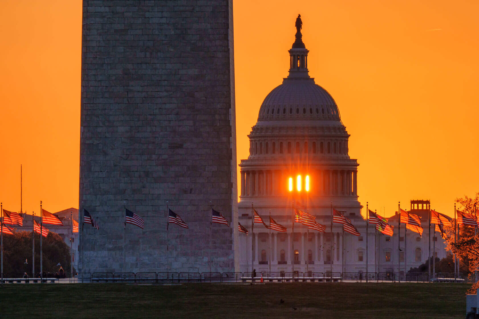 The rising sun flares through the windows of the U.S. Capitol Dome.
