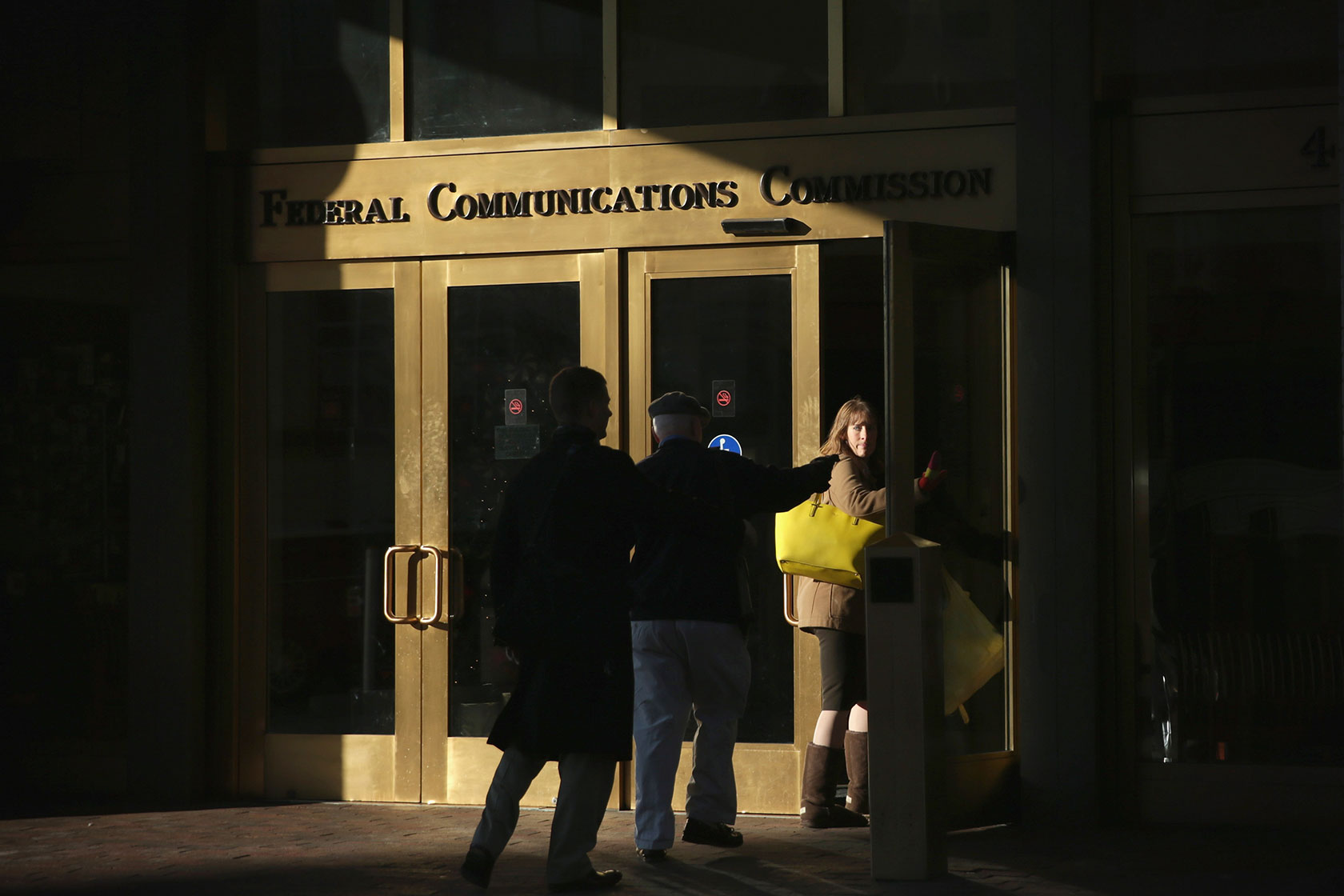 People enter the FCC building