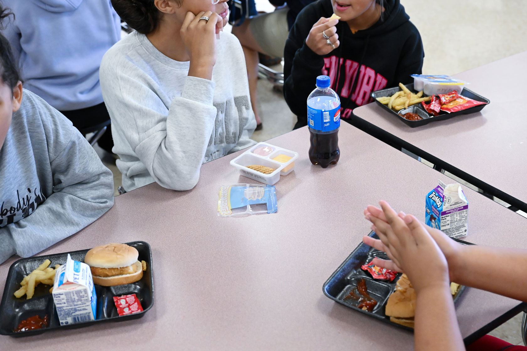 Students are seen eating lunch.