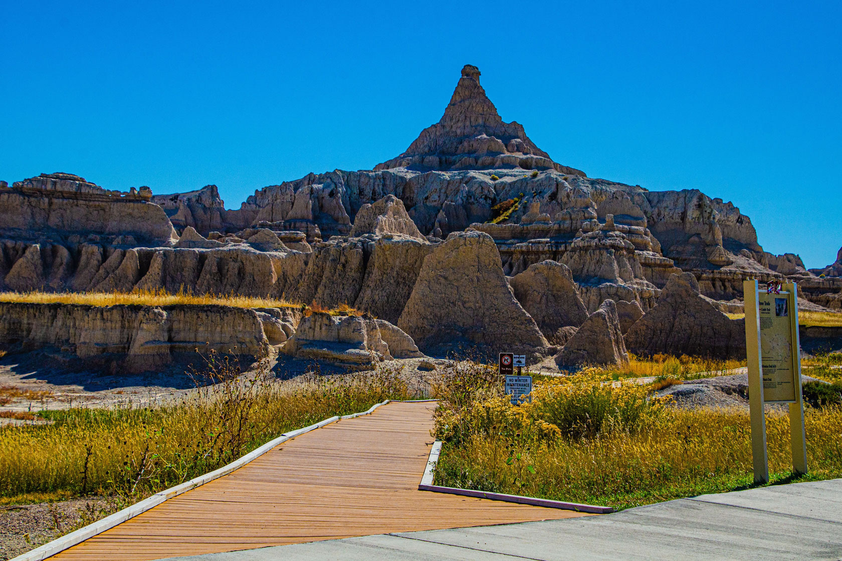 A trail leads to a rock formation.