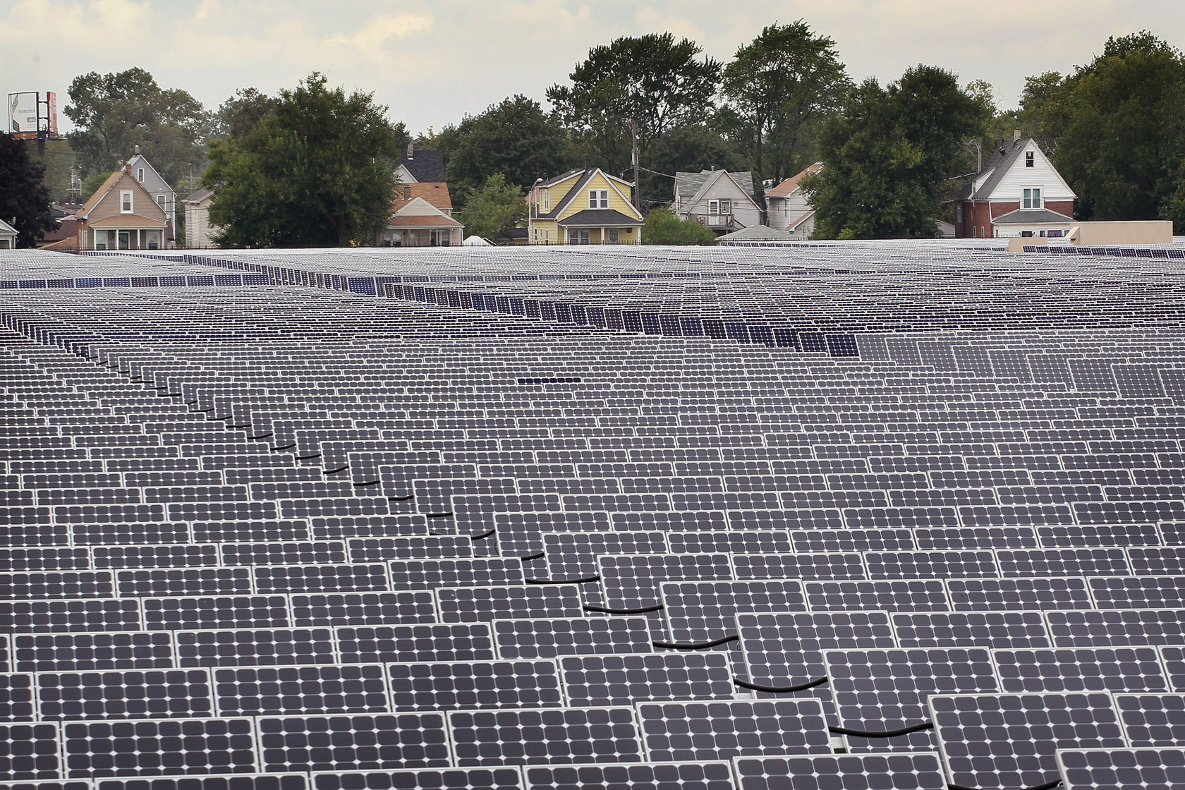 Rows of solar panels dominate land behind homes in Chicago.