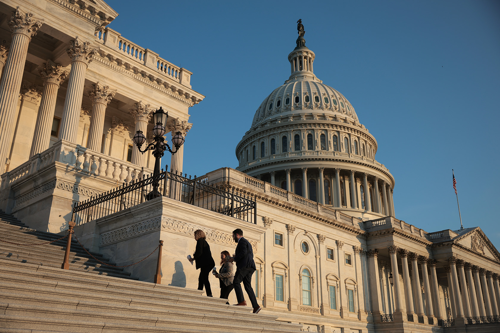 Members of the House walk up the steps of the U.S. Capitol.