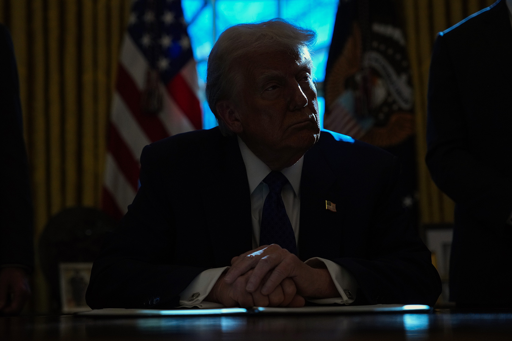 U.S. President Donald Trump signs an executive order.