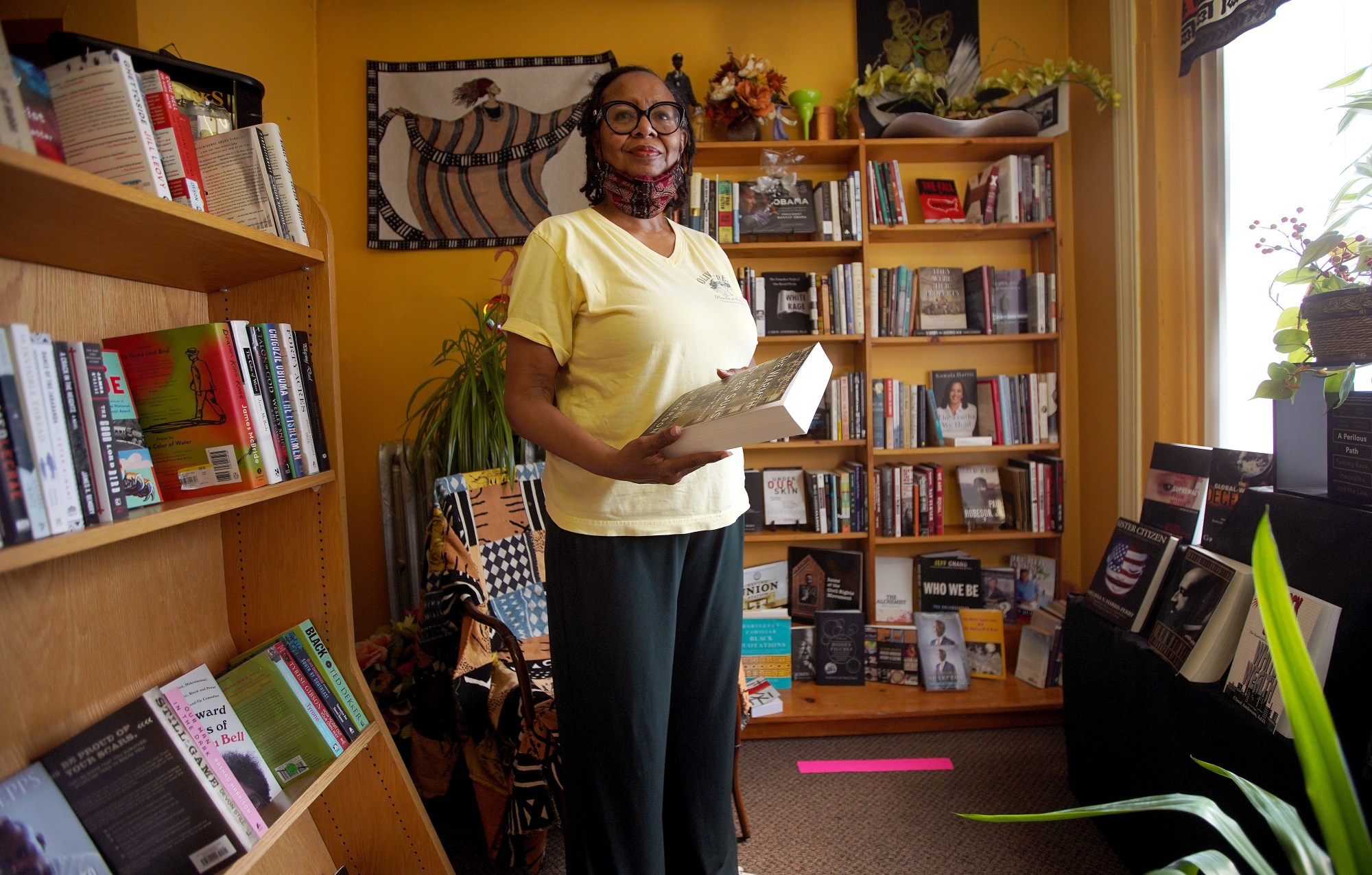 The owner of a book store poses for a portrait.