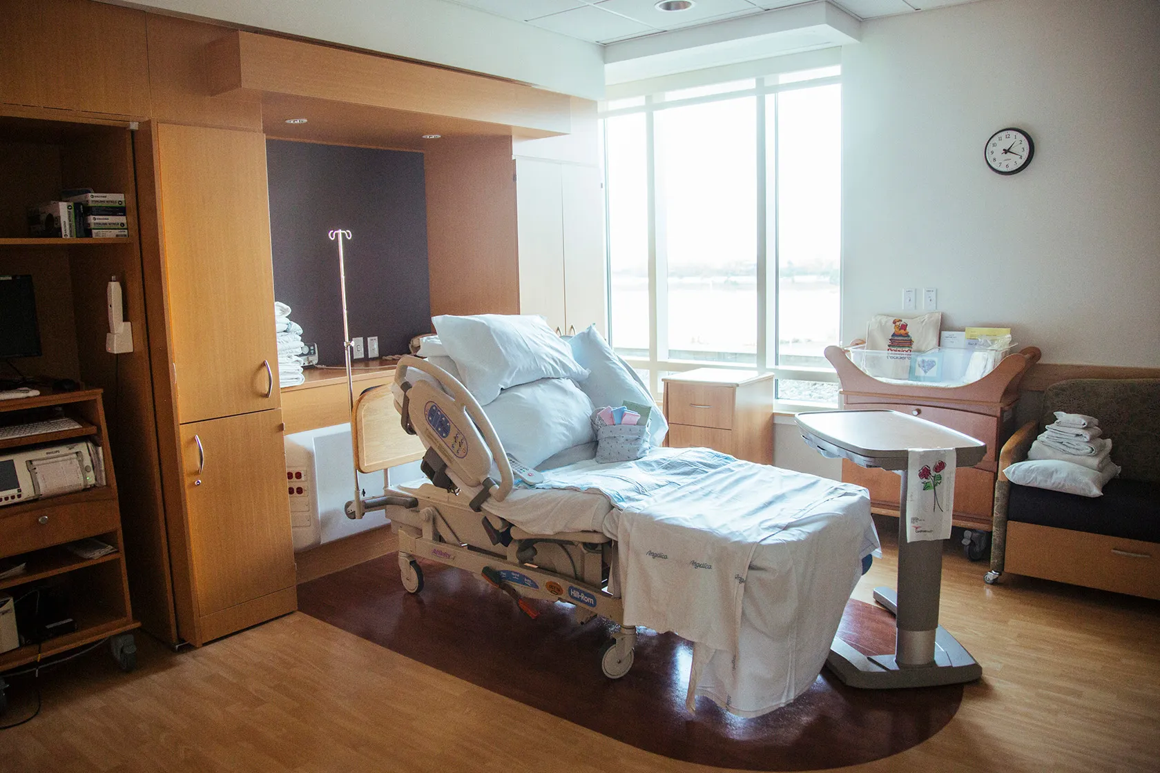 A hospital bed sits in the birthing room of a catholic hospital.