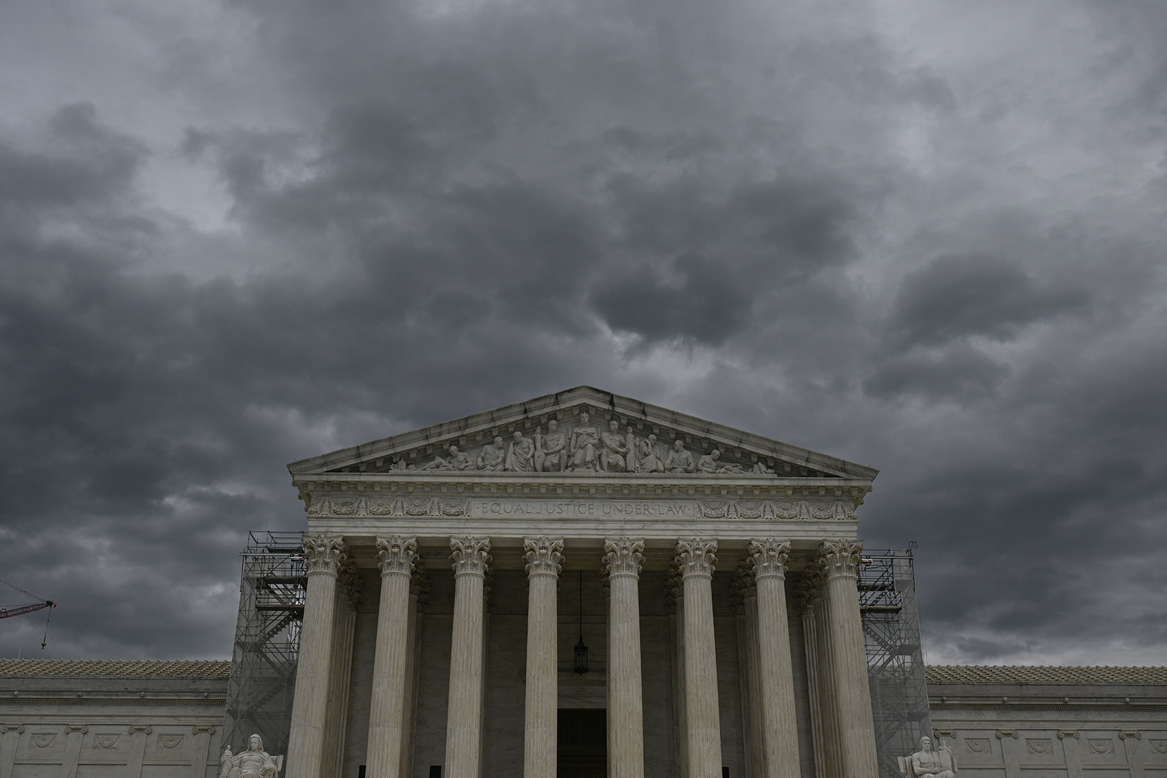 Supreme Court building beneath stormy sky