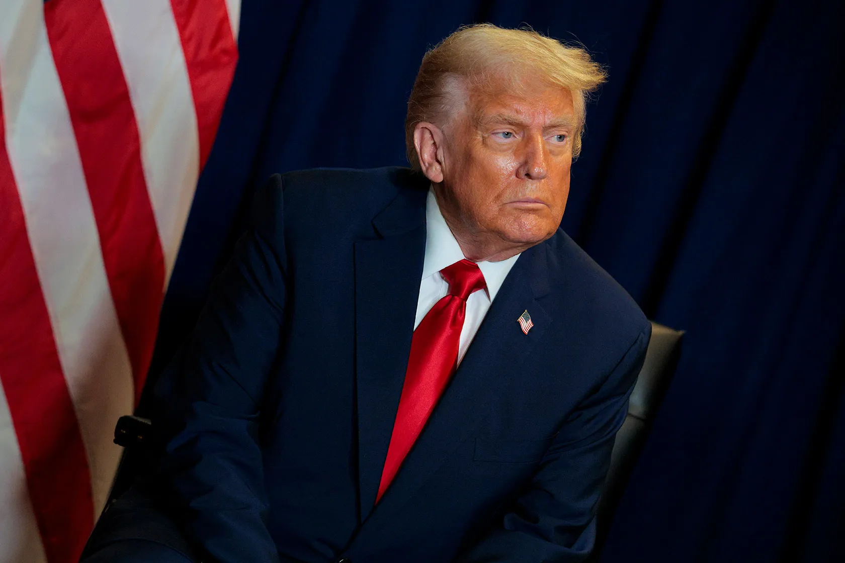 U.S. President Donald Trump looks on during a meeting.