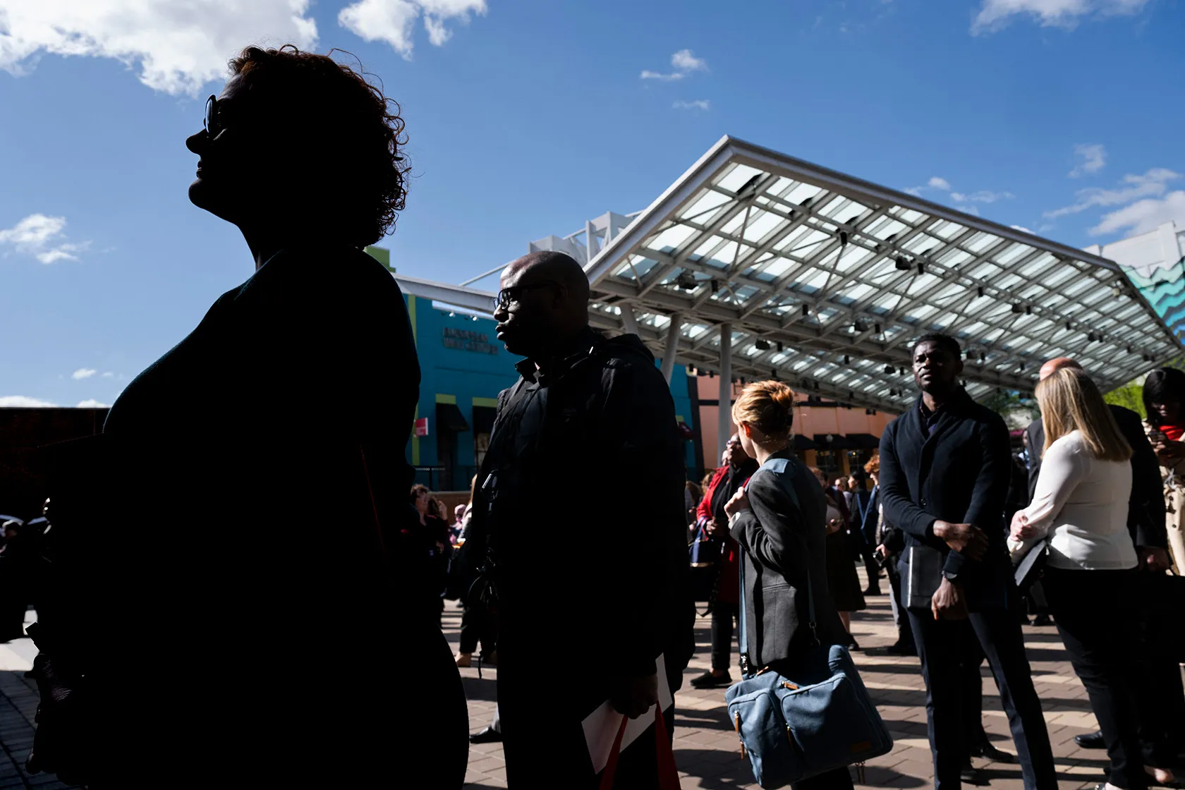 Job seekers line up to enter a job fair.
