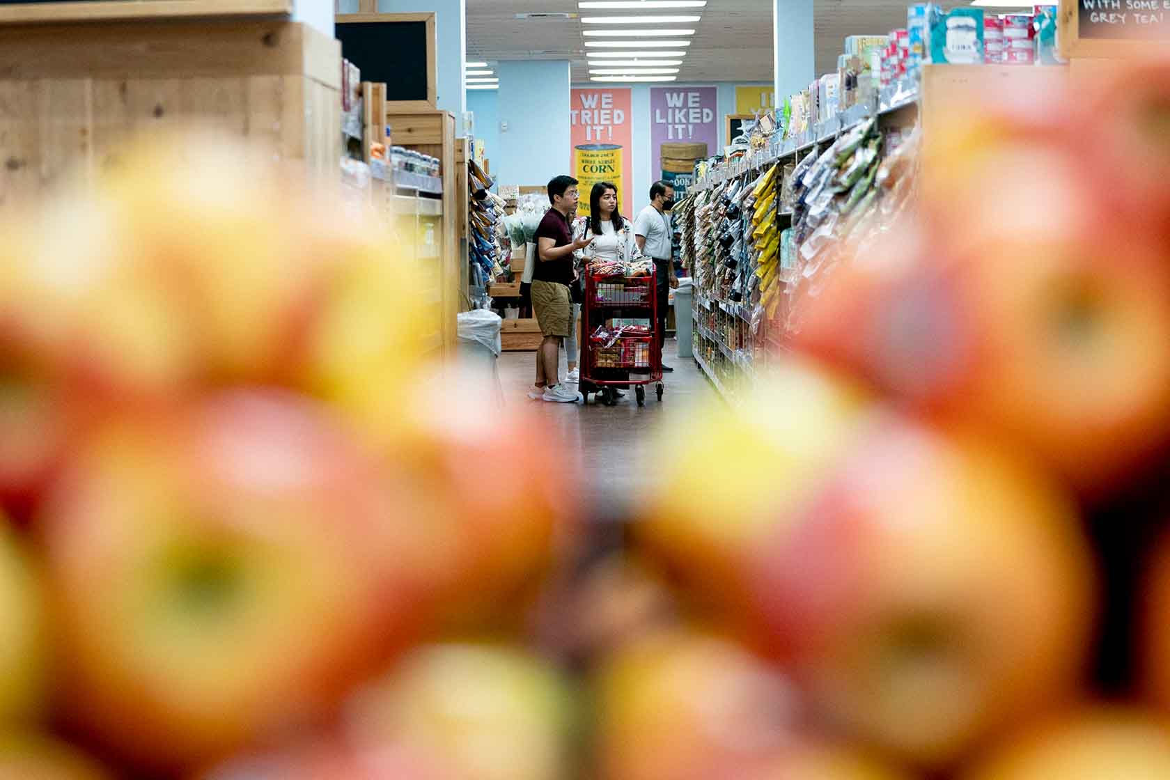 Shoppers walk through a grocery store in Washington, D.C.