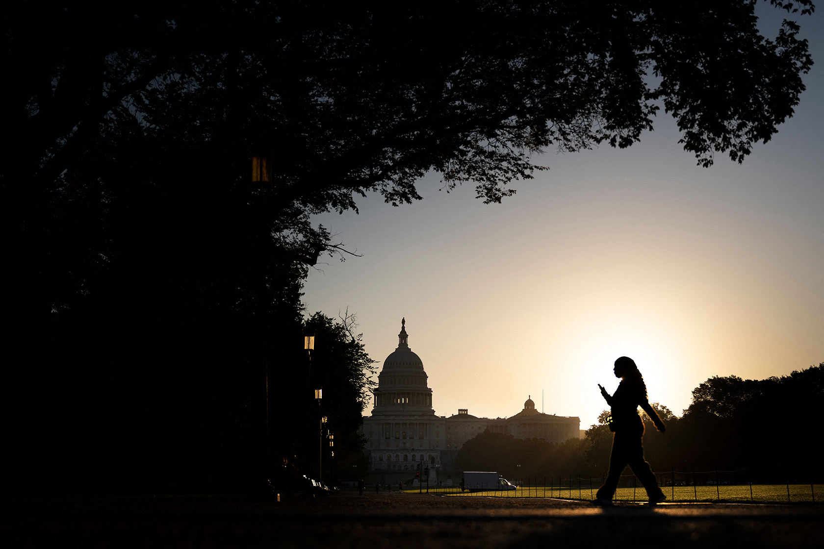 A woman walks along the National Mall.
